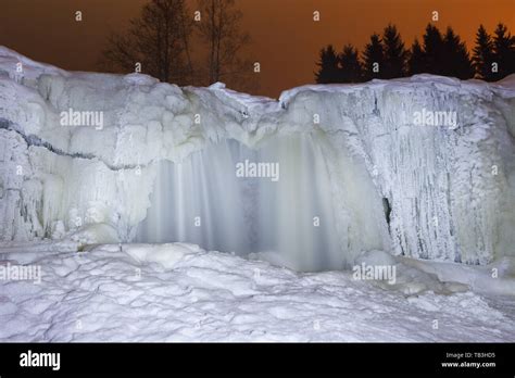 Frozen waterfall at night. Light painting illumination Stock Photo - Alamy