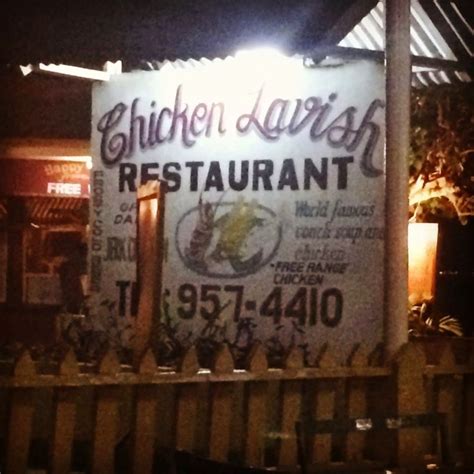 a restaurant sign is lit up at night