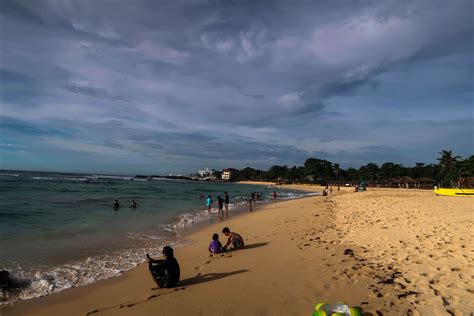 Filipinos chilling at a calm shoreline at Patar White Sand Beach in Bolinao, Pangasinan ...