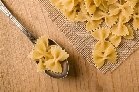 Raw farfalle bow-tie pasta stock photo. Image of uncooked - 86015112