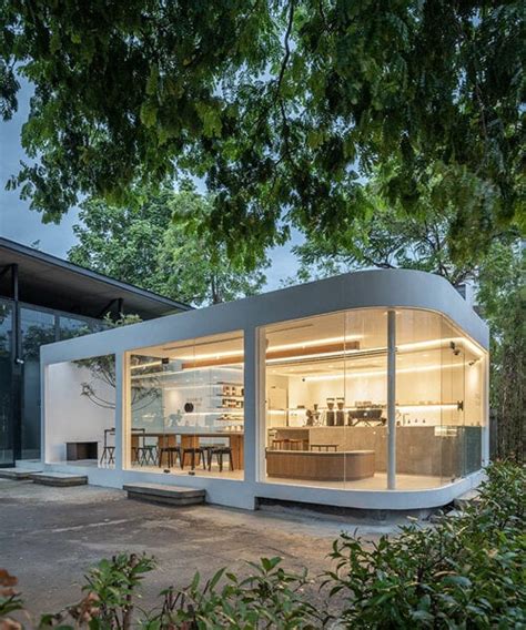 spacy architecture wraps serene bangkok cafe in floating glass