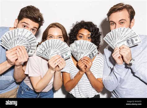 Close up of a group of happy multiracial people holding money banknotes ...