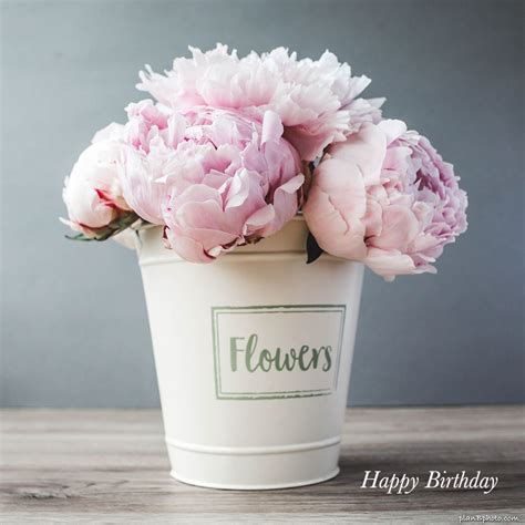 Pink peonies bouquet in a white bucket