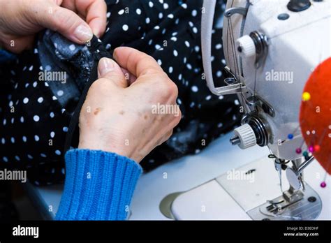 Hands work a sewing machine Stock Photo - Alamy