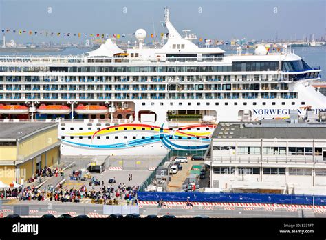 Norwegian Spirit cruise ship docked at Venice for disembarking holidaymakers at end of vacation ...