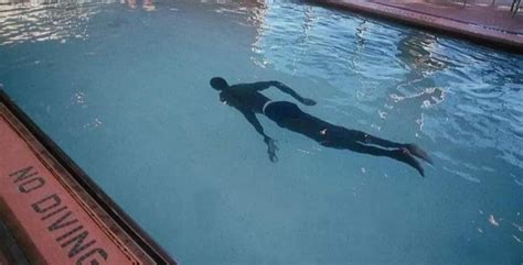 Former NBA player Manute Bol height 7’7 swimming in a pool in first pic ...