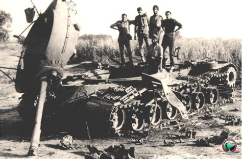 Indian soldiers standing on a destroyed Pakistani Patton tank after the Battle of Phillora ...