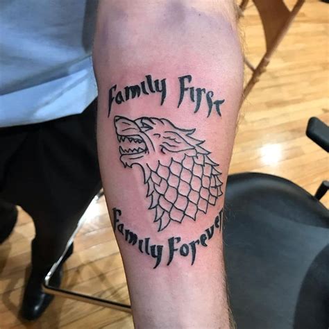 a man's arm with a game of throne tattoo on it