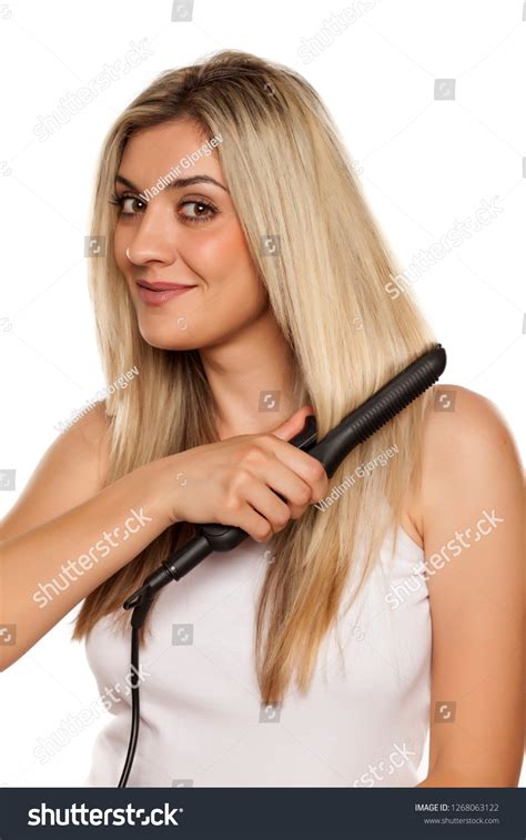 Smiling Young Woman Ironing Her Hair Stock Photo 1268063122 | Shutterstock