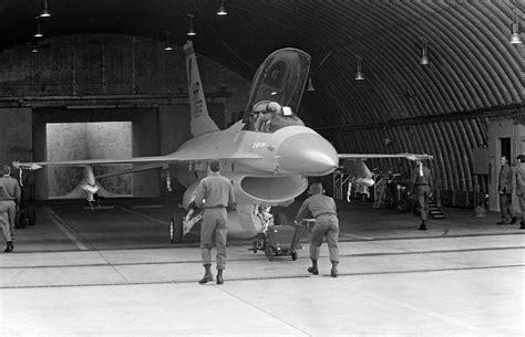 Members of the 50th Tactical Fighter Wing maneuver an F-16A Fighting ...