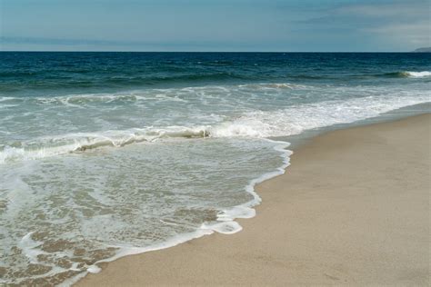 Photo of a Beach with Sea Foam · Free Stock Photo