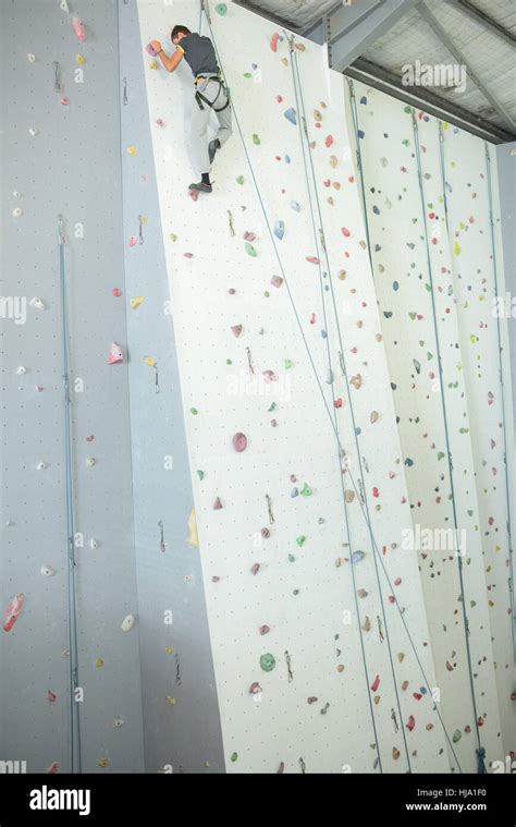 Person at top of indoor climbing wall Stock Photo - Alamy