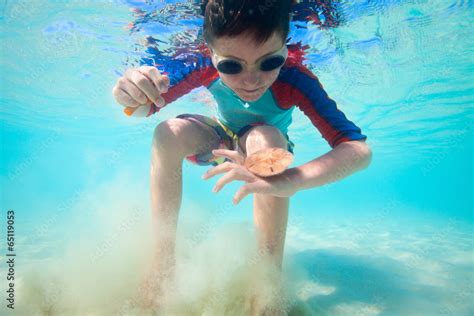 Boy swimming underwater Stock Photo | Adobe Stock