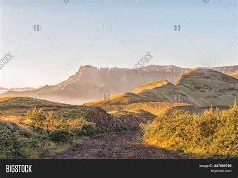 Sunrise On The Road To The Sentinel Car Park With The Amphitheatre In The Drakensberg In The ...