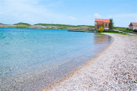 Private beaches, cottages, nature, lake side view, clear water, Armenia. Lake Sevan fresh water ...