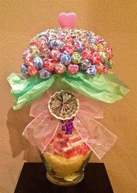 Dum-Dums Bouquet (front view) Made with 125 candy Dum-Dums suckers. Inside the glass vase is a ...