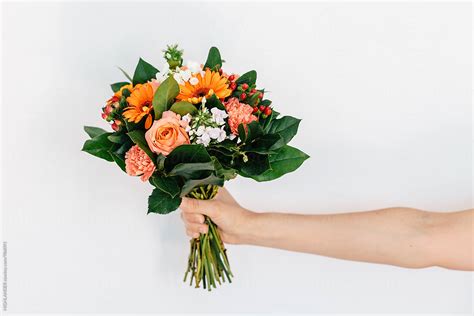 Woman's Hand Holding A Bouquet Of Flowers. | Stocksy United