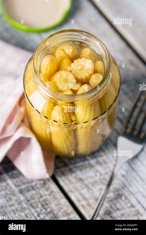 Pickled young baby corn cobs in jar Stock Photo - Alamy