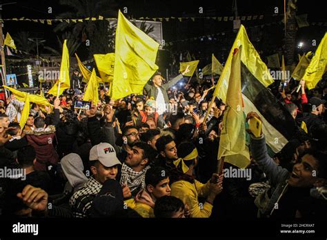 Palestinian Fatah supporters wave their yellow flags during a rally ...