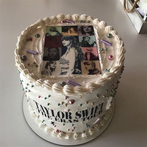 a white cake decorated with photos and confetti