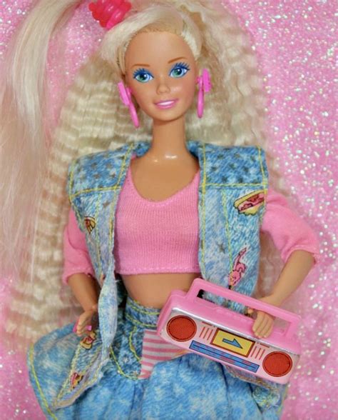 a barbie doll is holding a pink radio