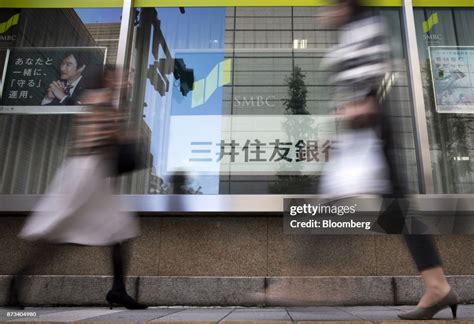 Pedestrians walk past a Sumitomo Mitsui Banking Corp. branch in... News Photo - Getty Images