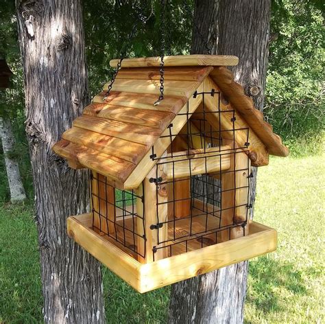 a wooden bird house hanging from a tree