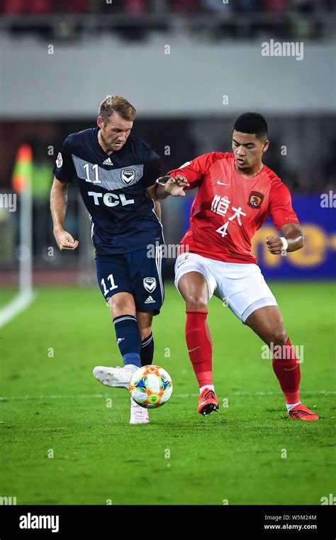 Tyias Browning, right, of China's Guangzhou Evergrande challenges Ola ...