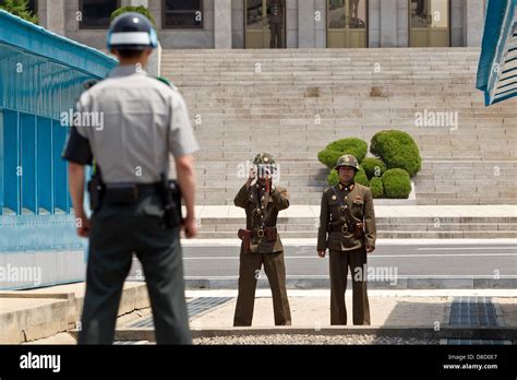 North Korean border soldiers take pictures of a South Korean border post at the demilitarized ...