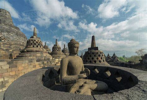 Buddha statue on Temple of Borobudur, Borobudur, Indonesia - Stock Photo - Dissolve