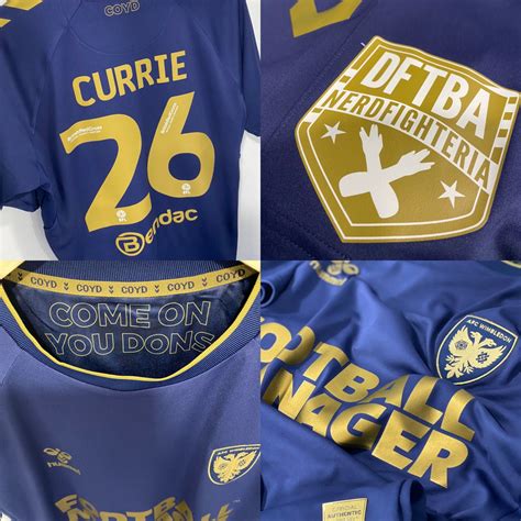 The new blue and gold AFC Wimbledon away kit, with a golden DFTBA crest ...