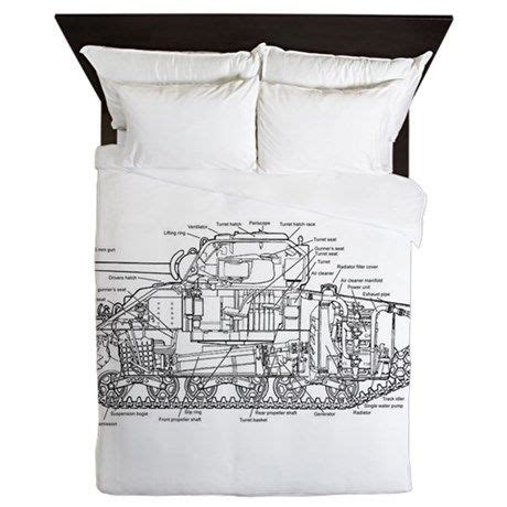 a bed with a drawing of a train on it's back cover and pillow cases