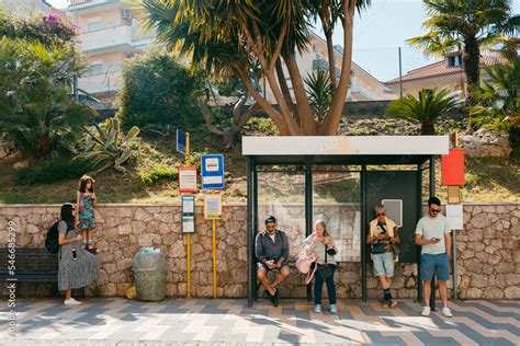 People waiting in bus stop checking their smartphones Stock Photo ...