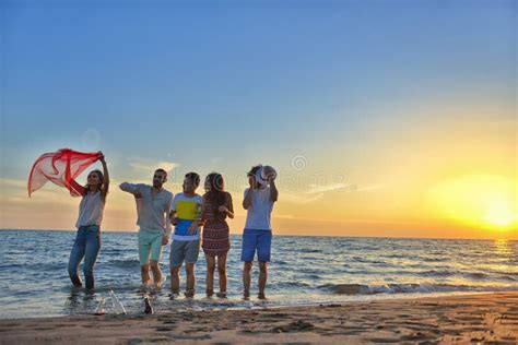 Group of Happy Young People is Running on Background of Sunset Beach and Sea Stock Photo - Image ...