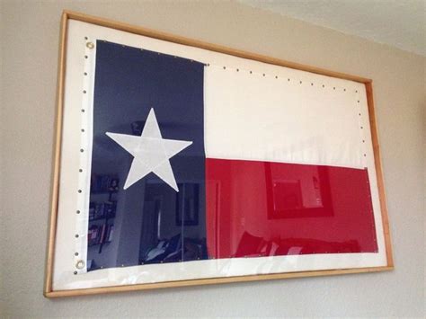 the texas state flag is hanging on the wall