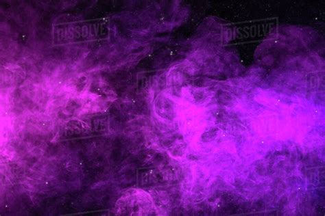 Pink and purple smoke on black background as universe with stars - Stock Photo - Dissolve