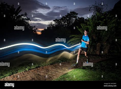 Trail runner running at night Stock Photo - Alamy