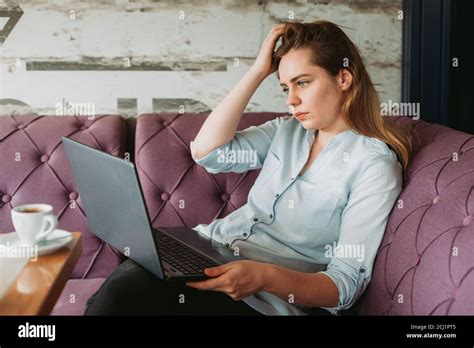 Girl is working on laptop in coffee place Stock Photo - Alamy