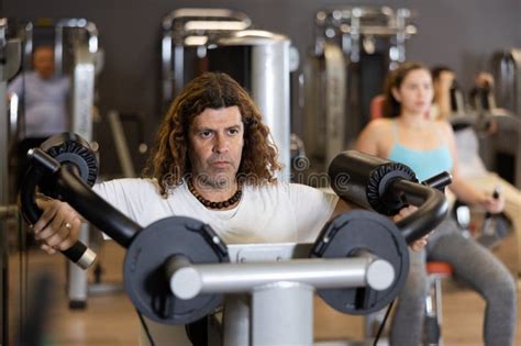 Portrait of Athletic Man during Workout with Power Exercise Machine in Gym Stock Photo - Image ...