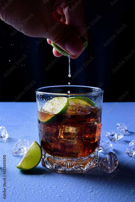 Glass of coke with lemon Stock Photo | Adobe Stock