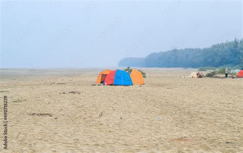 Campsite on the beach. Tents on a sea beach with sky and green ...