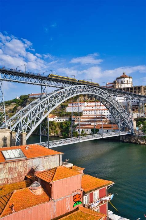 Vertical Shot of a Beautiful Bridge Above the Water in Oporto, Portugal ...