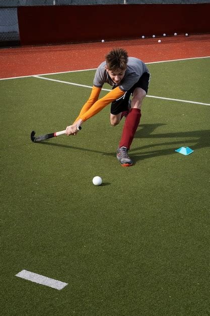 Free Photo | Field hockey player in equipment on the grass