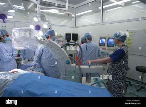 Medical staff in a hospital operating theatre during an operation Stock Photo: 124522184 - Alamy