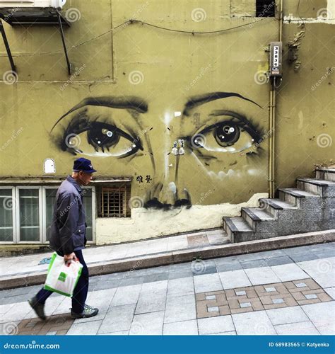 Sheung Wan, Hong Kong Street Art: Man Walking Past Mural Editorial ...