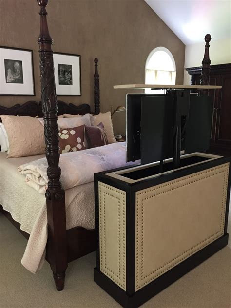 end of bed leather studded TV lift cabinet by Cabinet Tronix.. in up position. - Transitional ...