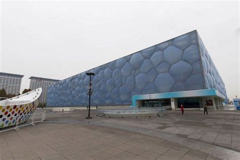 a large building with a giant white boat in front of it and people ...