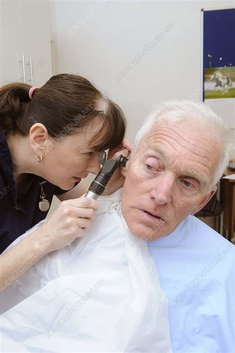 Otoscope ear examination - Stock Image - C011/5529 - Science Photo Library