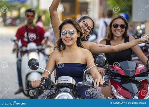 A Young Woman with Happy Girl Riding a Motorcycle on Road. Asian Girls ...