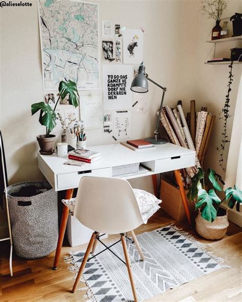 a white desk topped with lots of books and plants